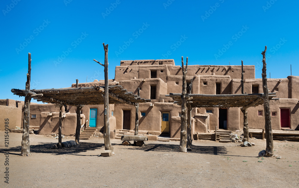 Adobe Buildings with Shade Structures. Taos Pueblo, New Mexico, continuously inhabited for over 1000 years.