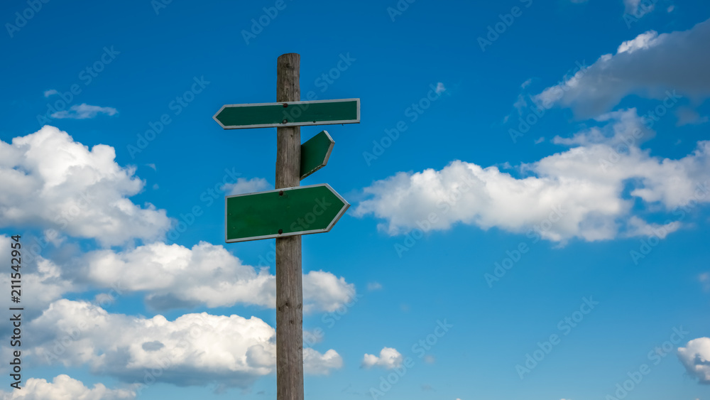 the direction sign with clouds background