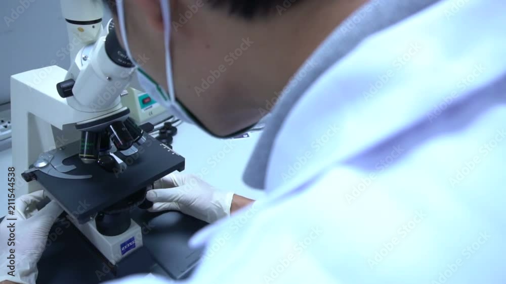 Scientist mix chemicals with The shake machine Before the experiment.Mixture laced with samples into test tubes,Thailand scientist working in the lab Scientist mix chemicals with The shake machine Before the experiment.Mixture laced with samples into test tubes,Thailand scientist working in the lab