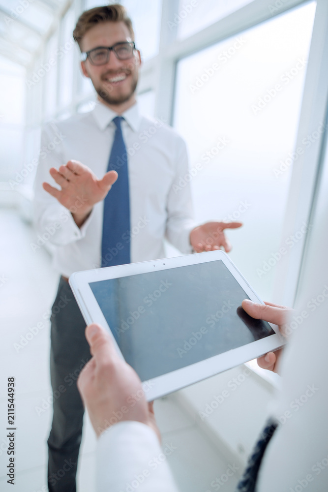 close up.businessman with digital tablet on office background close up.businessman with digital tablet on office background