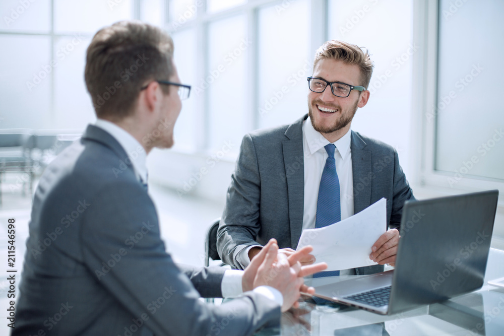 business partners discussing business document. business partners discussing business document.