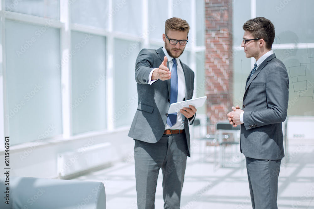 project Manager and employees talking standing in the office project Manager and employees talking standing in the office