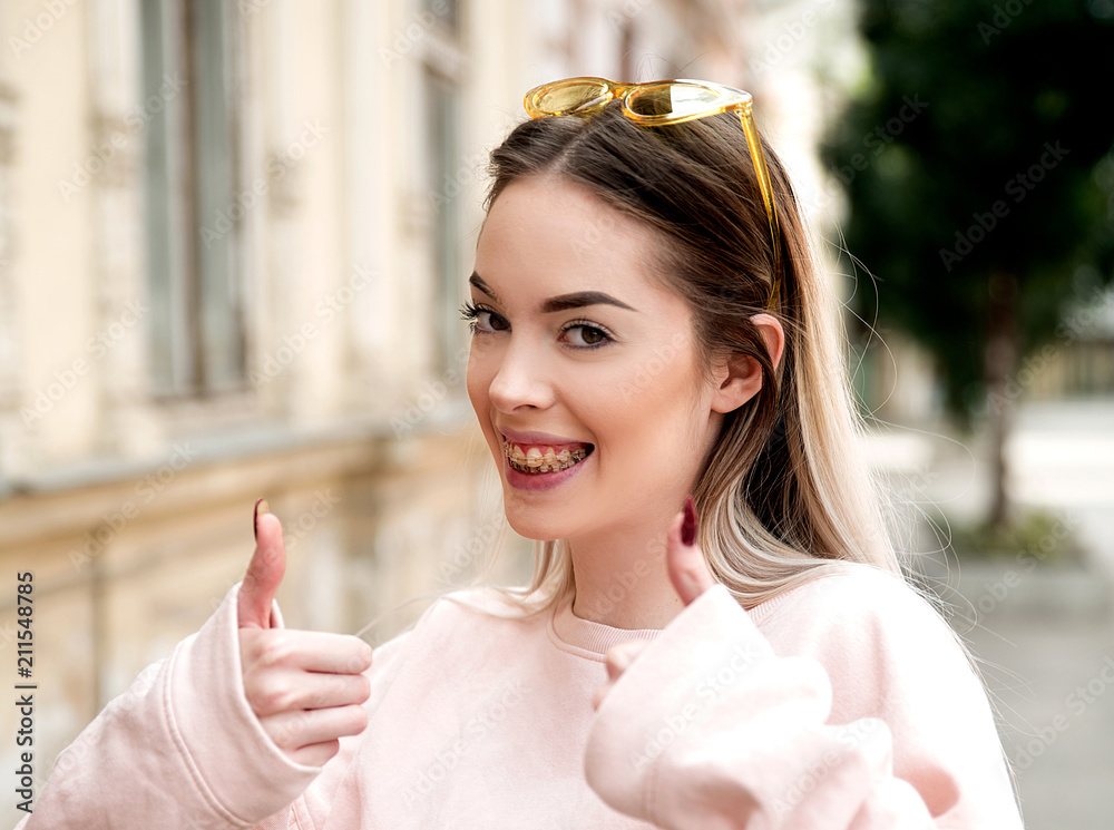 Young woman showing thumbs up gesture