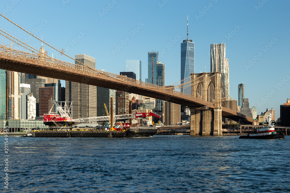 New York City / USA - JUN 25 2018: Brooklyn Bridge Park with Lower Manhattan skyline at sunrise