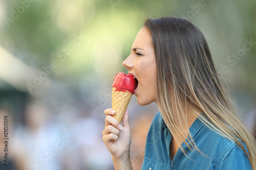 Woman with hypersensitivity biting an ice cream