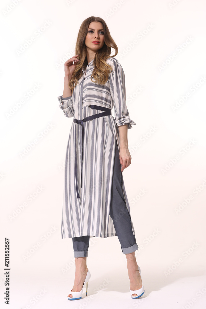 young caucasian business woman executive posing in summer long tunica dress with belt high heels stiletto shoes full body length isolated on white young caucasian business woman executive posing in summer long tunica dress with belt high heels stiletto shoes full body length isolated on white
