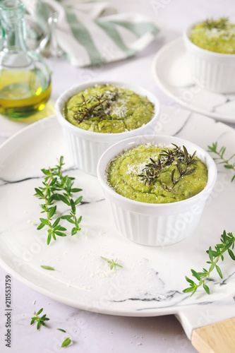 Appetizer: green vegetable soufflе with grated Parmesan cheese and olive oil, three servings