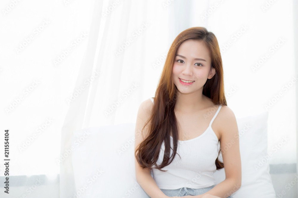 Portrait beautiful young asian woman sitting and smile the window at bedroom while wake up with sunrise at morning, lifestyle and relax concept. Portrait beautiful young asian woman sitting and smile the window at bedroom while wake up with sunrise at morning, lifestyle and relax concept.