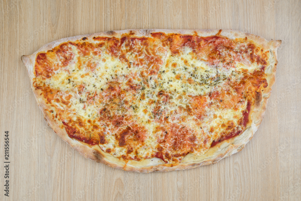 Pizza calzone time on light wooden table background