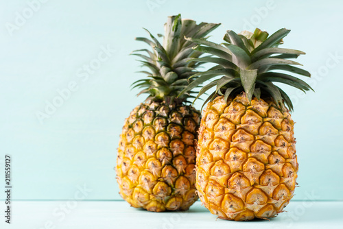 Ripe pineapple on green background, tropical fruit