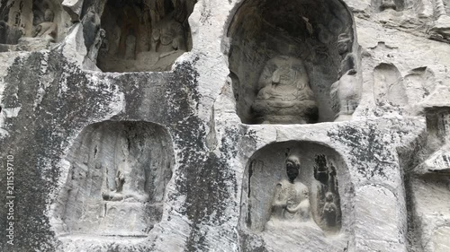 Walking and looking the Buddha Statues in close-up, Longmen Grottoes park, China