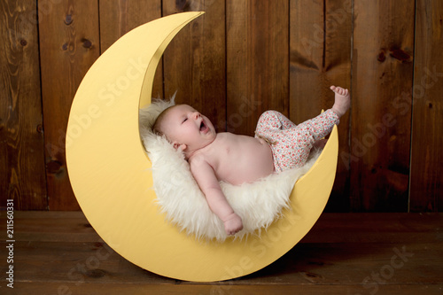 Baby Girl Lying on a Moon Shaped Photo Prop