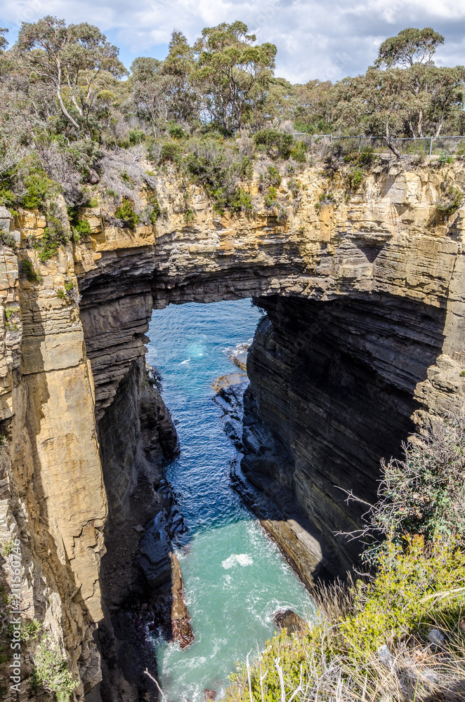 Tasman Arch is a natural sea bridge between the Tasman Sea and a large 