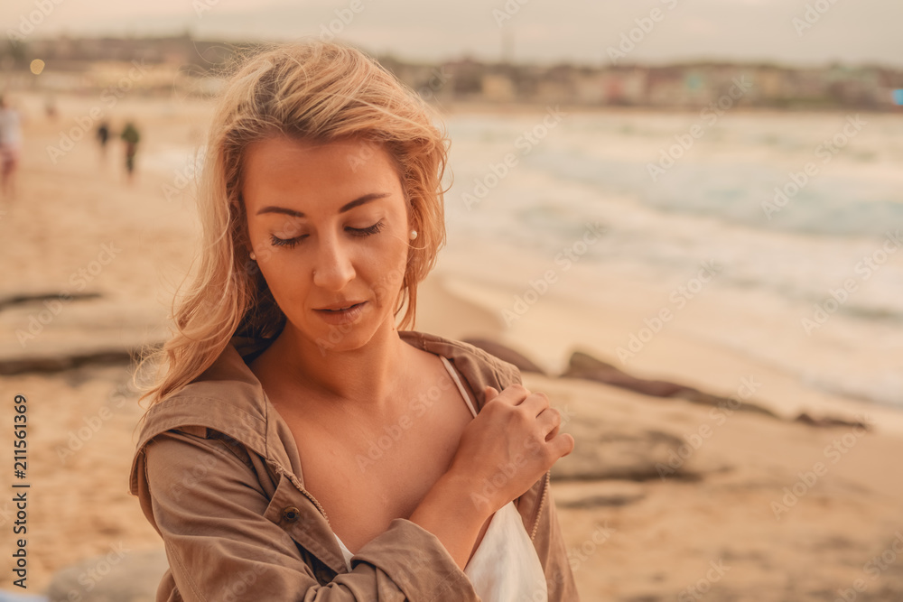 Blonde surfer girl relaxing by the beach Blonde surfer girl relaxing by the beach