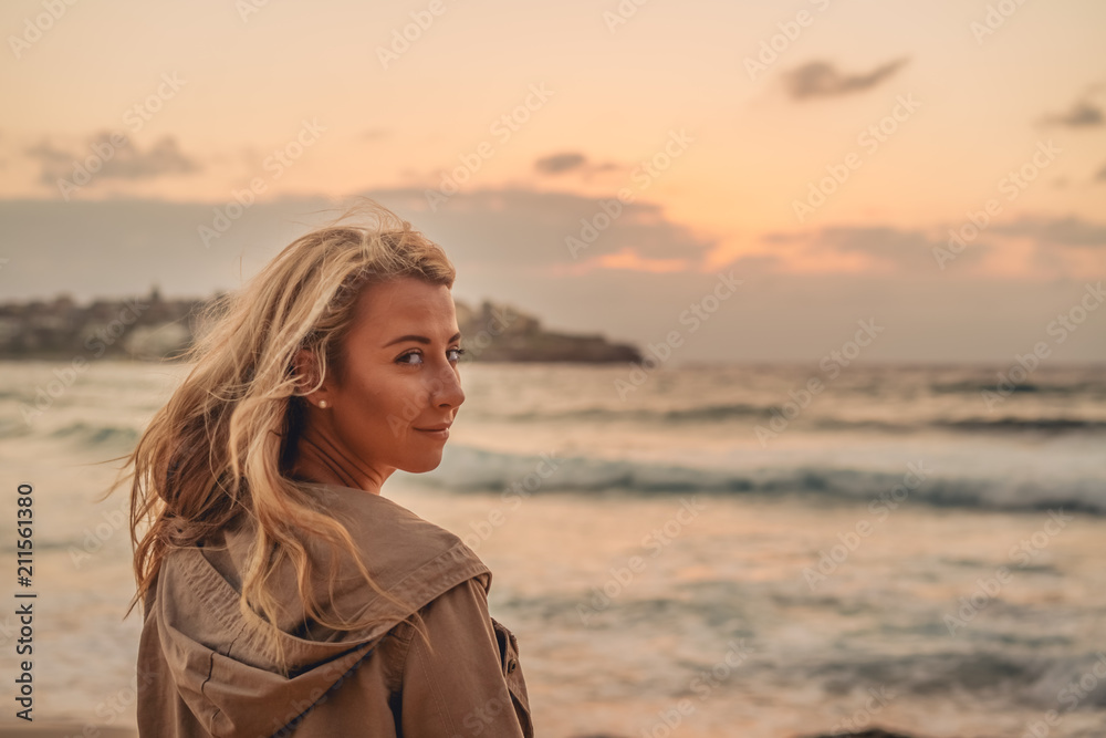 Blonde surfer girl relaxing by the beach Blonde surfer girl relaxing by the beach