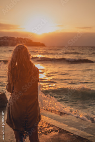 Blonde surfer girl relaxing by australian beach