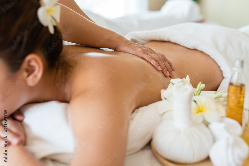 Young beautiful Asian woman sleep relaxing in the Oil spa massage in salon. Select focus hand of masseuse Young beautiful Asian woman sleep relaxing in the Oil spa massage in salon. Select focus hand of masseuse