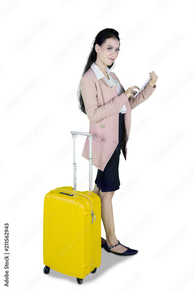 Pretty businesswoman with luggage and tablet Pretty businesswoman with luggage and tablet