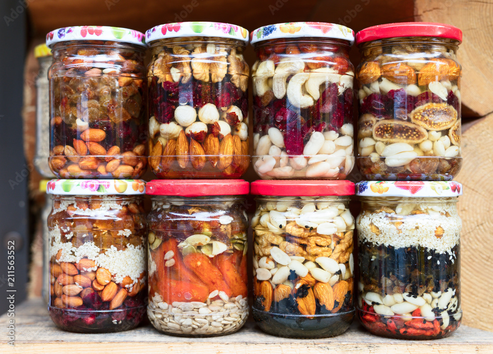 Various canned vegetables, nuts, and mushrooms in the glass jars. Various canned vegetables, nuts, and mushrooms in the glass jars.