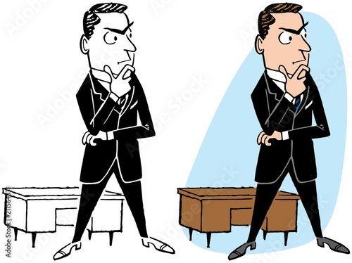 A businessman stands at his desk and thinks.