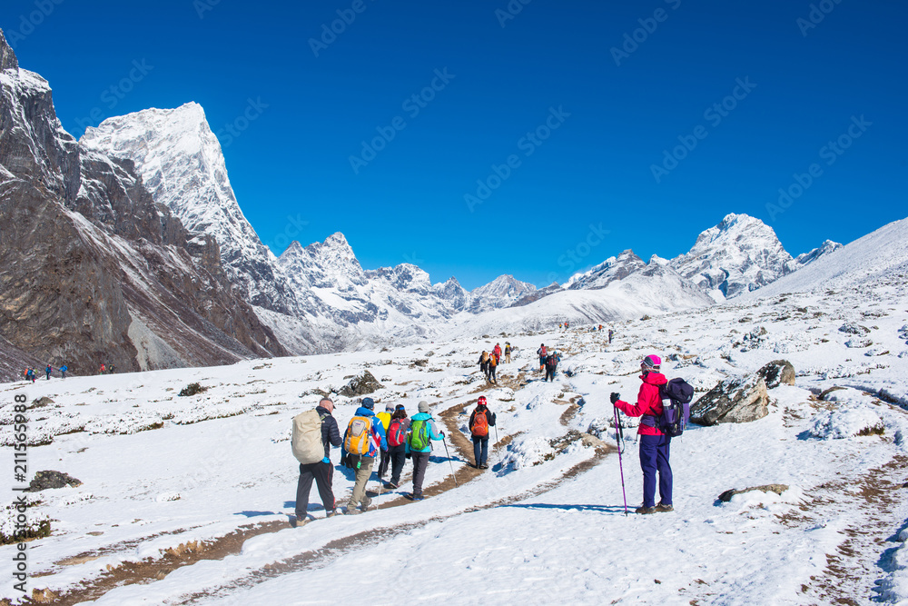 trekker are trekking on the snow mountain to Everest base camp