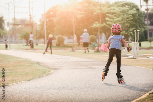 Girl playing roller skates with friends outdoors.