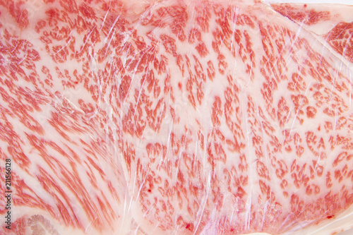 close up of raw wagyu sirloin beef wrapped in plastic wrap for background