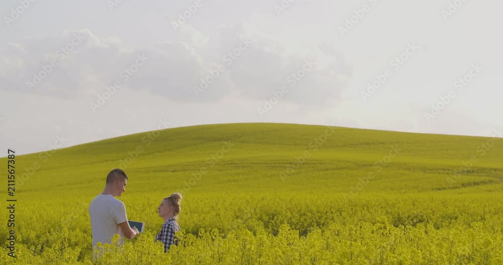 Farmers Talking While Walking On Agricultural Field Farmers Talking While Walking On Agricultural Field