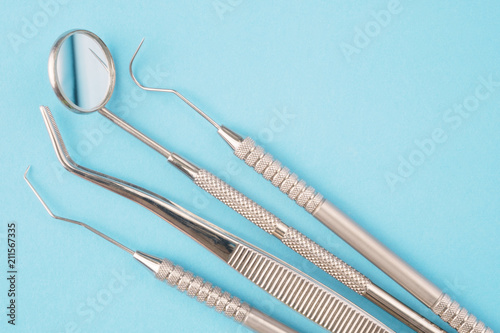 Dental tools use for dentist on the blue background, flat lay, top vipw. photo