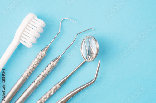 Dental tools use for dentist on the blue background, flat lay, top vipw. photo