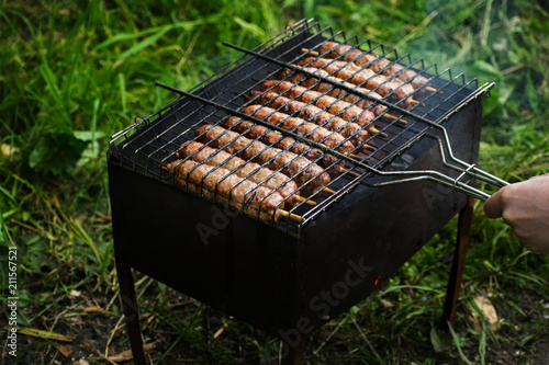 Lulya kebab from meat are prepared in the grill. Shish kebab in the grill. photo