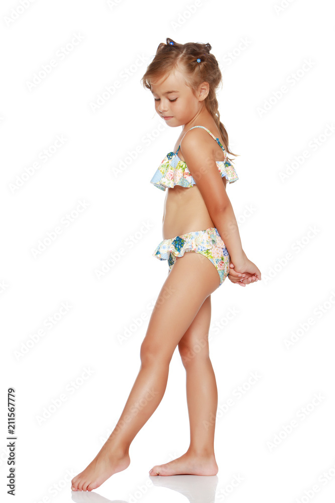 Tanned little girl in a swimsuit Stock Photo