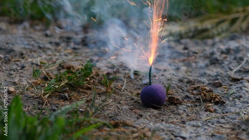 Purple smoke ball being lit for July 4 event