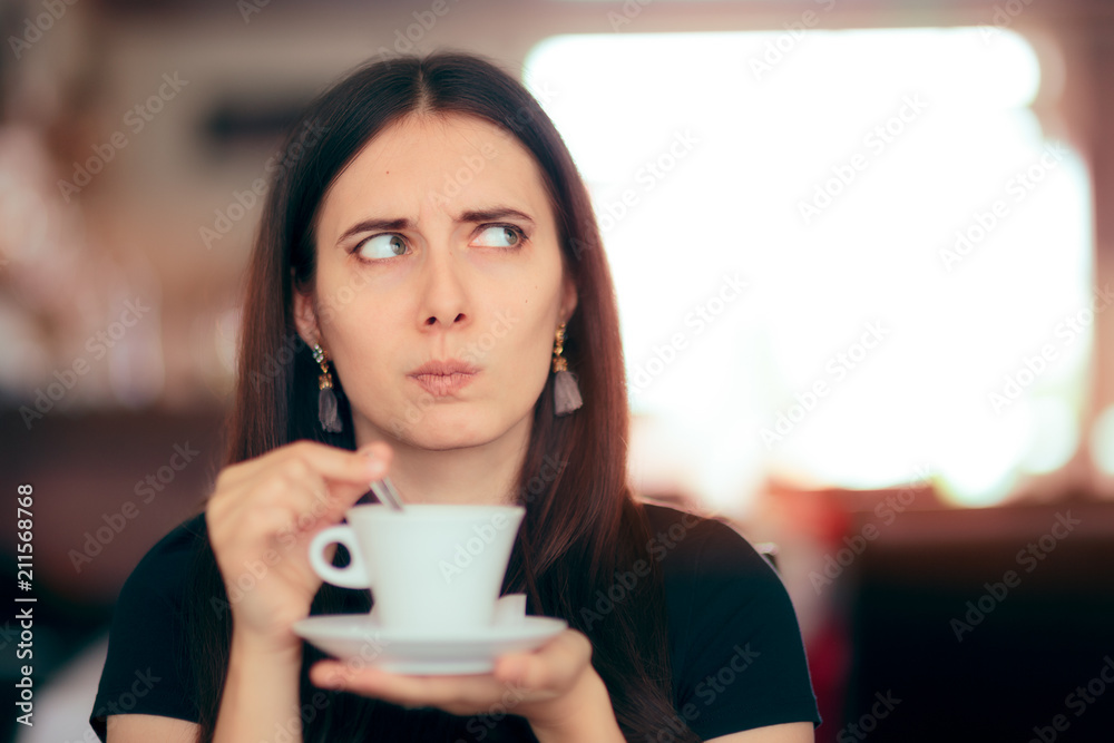 Surprised Woman Drinking Coffee in a Restaurant Surprised Woman Drinking Coffee in a Restaurant