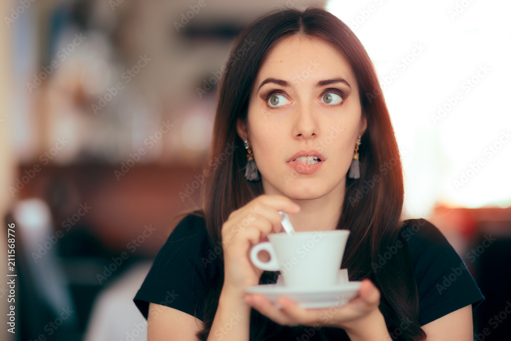 Surprised Woman Drinking Coffee in a Restaurant Surprised Woman Drinking Coffee in a Restaurant
