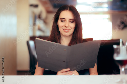 Female Customer Reading Menu in a Restaurant