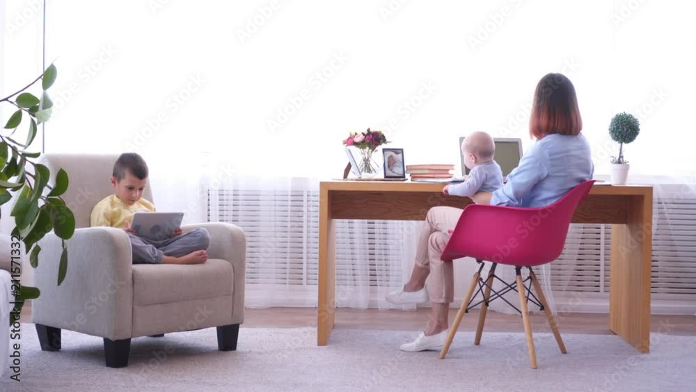 Woman trying to work from home with children Woman trying to work from home with children