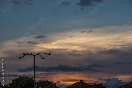 Dramatic sky on sunset and lamp