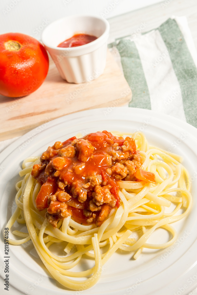 spaghetti with amatriciana sauce in the dish on the wooden table spaghetti with amatriciana sauce in the dish on the wooden table