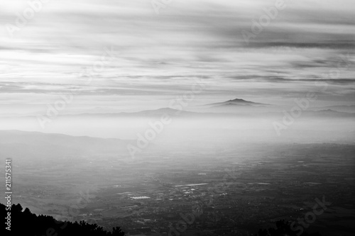 Subasio Mt. (Umbria, Italy), with sky covered by clouds and mist on the valley underneath
