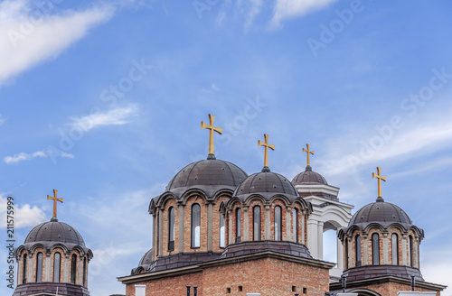 Roof and top of ortodox christian church with cloudy blue sky photo