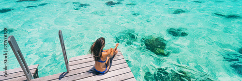 Luxury beach vacation travel destination woman relaxing on idyllic paradise blue turquoise clear water for snorkeling. Banner panorama with background texture on ocean.