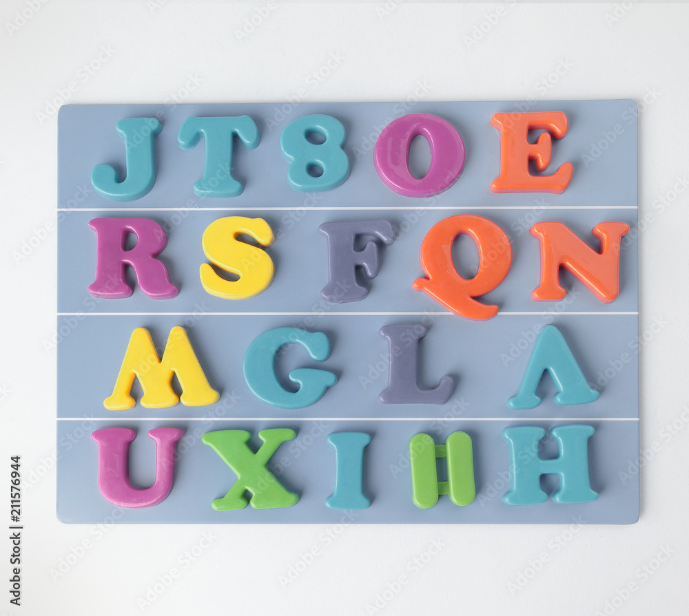 plastic magnetic colored english alphabet on blue background plastic magnetic colored english alphabet on blue background