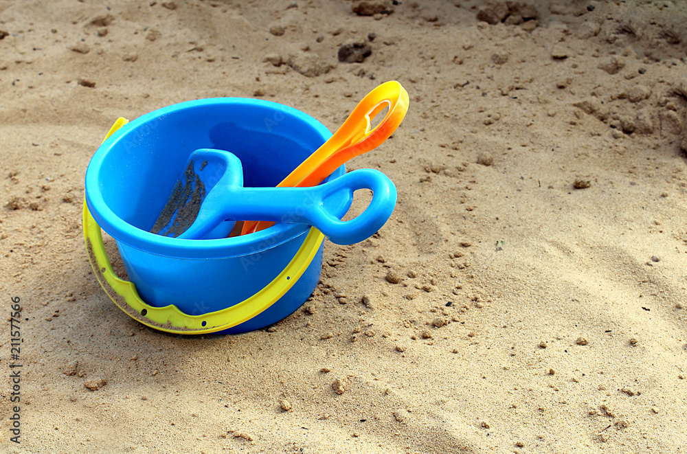 children's shovel rake and bucket on the sand children's shovel rake and bucket on the sand