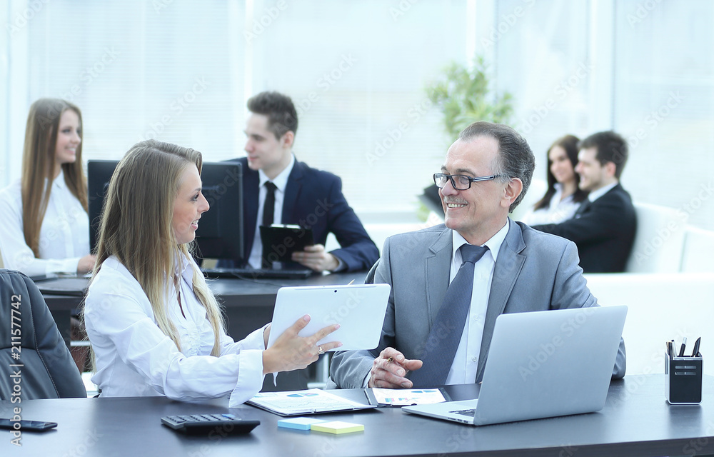 employees using digital tablet to work with financial data employees using digital tablet to work with financial data