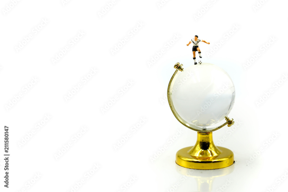 Miniature people : Soccer player man standing on globe worldmap,football world championship cup concept. Miniature people : Soccer player man standing on globe worldmap,football world championship cup concept.