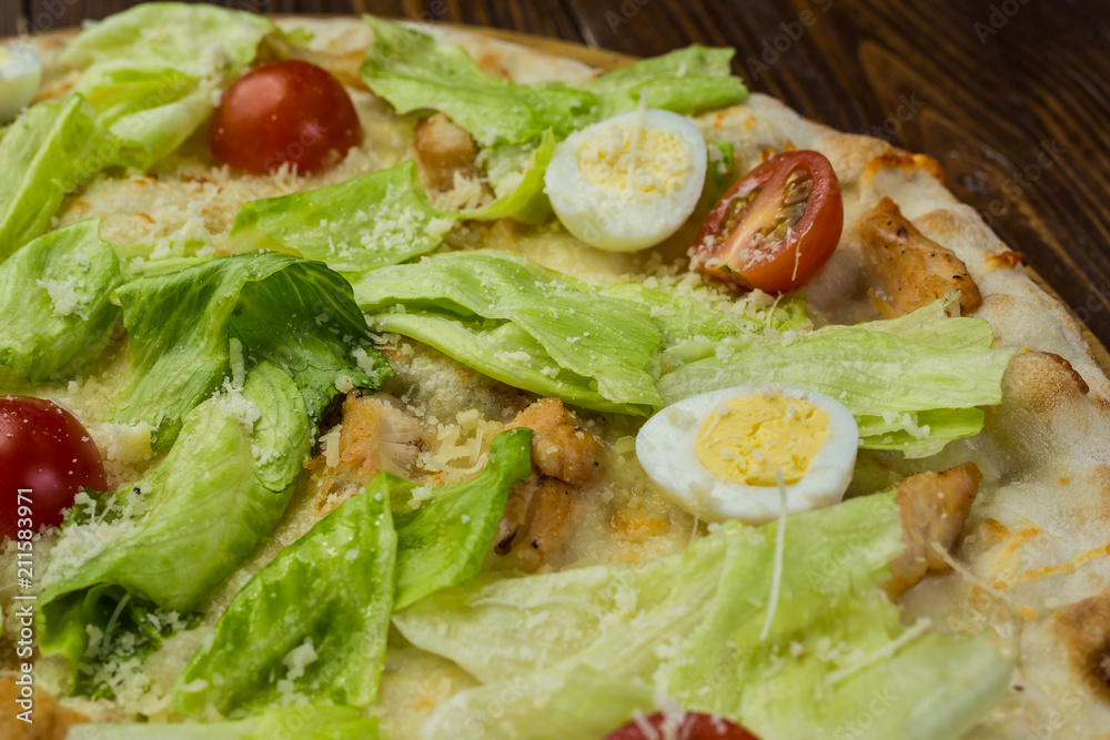 Pizza Caesar with chicken and tomatoes on wooden background Pizza Caesar with chicken and tomatoes on wooden background