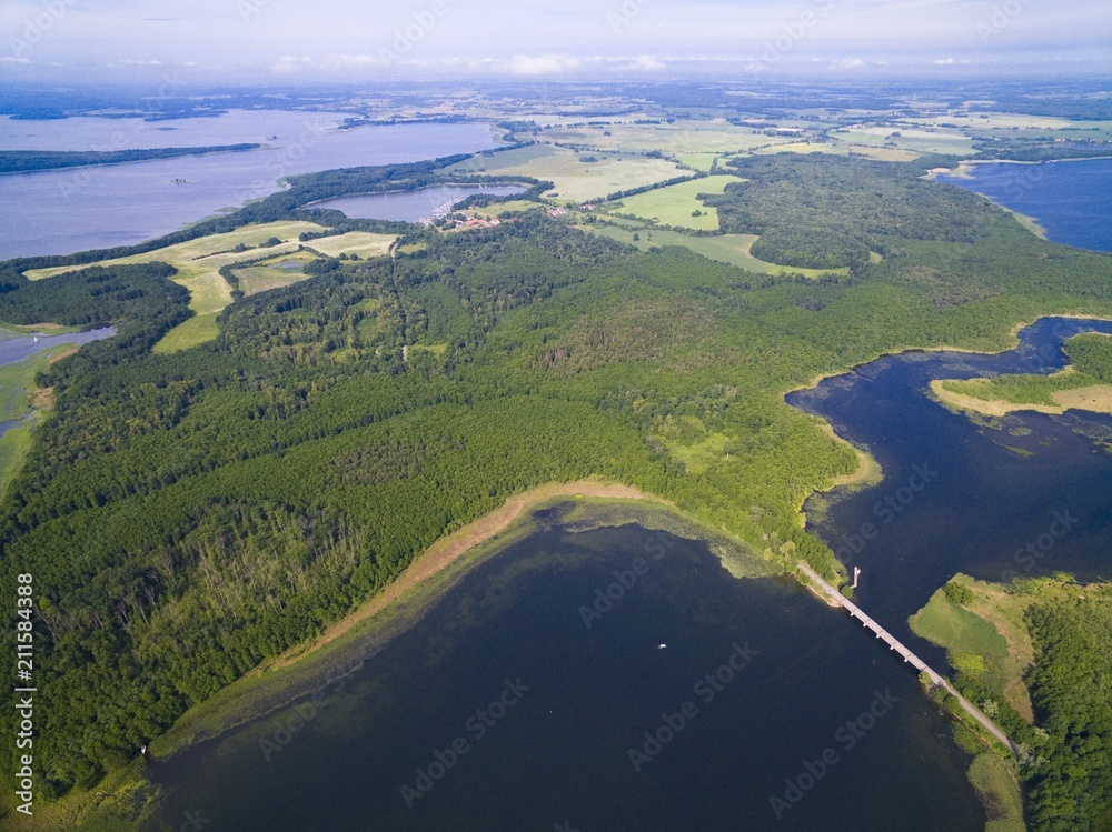 Aerial view of beautiful landscape of lake district, bridge between Dargin and Kirsajty Lakes, Sztynort in the background, Mazury, Poland