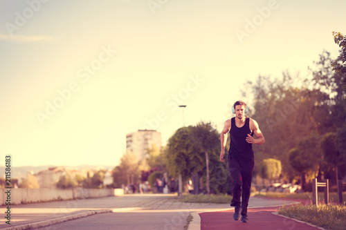 Man jogging in the morning out on the race track