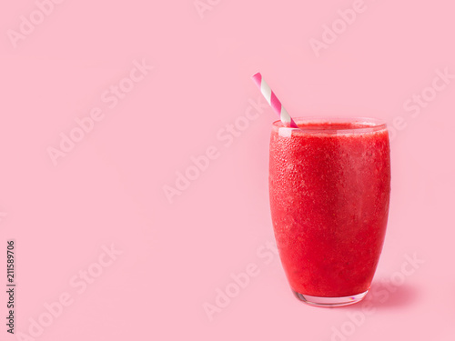 Red smoothie on pink backgrund. Pastel minimalism photo